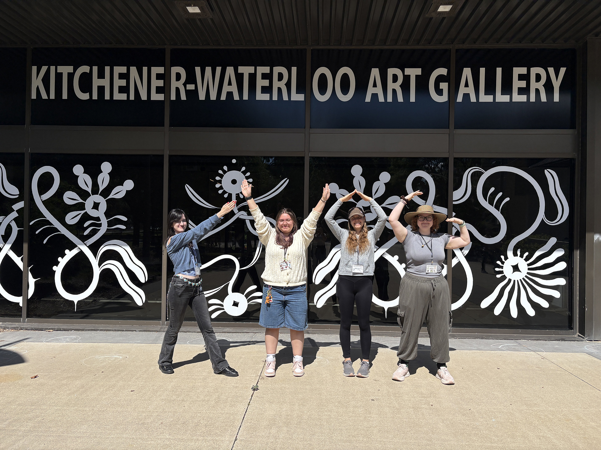Four of the Summer Camp Instructors uding their bodies to spell out the acronym KWAG
