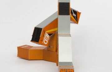 Orange-colored HO scale model parts of a toy truck merged with shipping containers