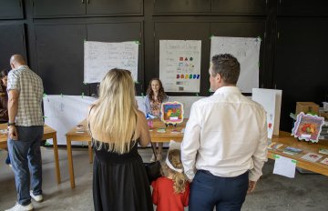 Family members check out a table of artworks in the KWAG interactive space
