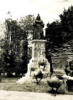 Black and white Shelley Niro photograph of Queen Victoria statue in Victoria Park with ghostly superimposed image of geese passing through the statue's plinth