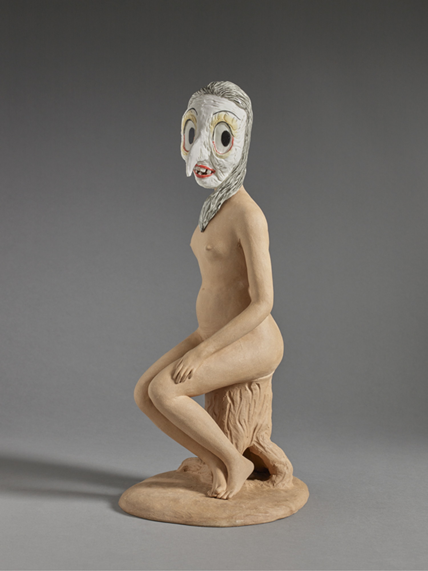 Shary Boyle's Looney Tunes (2016) is a ceramic sculpture of a young nude maiden seated on a tree stump, her body and setting are unglazed terracotta while her head is that of a cartoonish witch rendered in brightly glazed ceramic