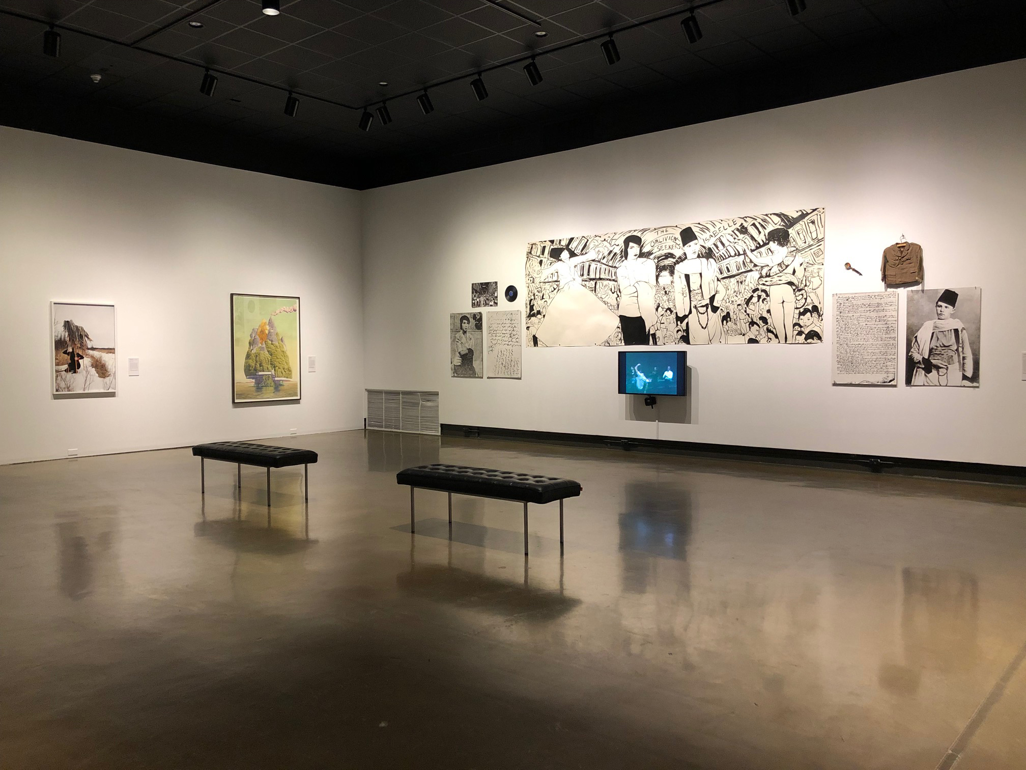 Installation view of At the far edge of worlds showing two framed works and a large mixed media installation with video