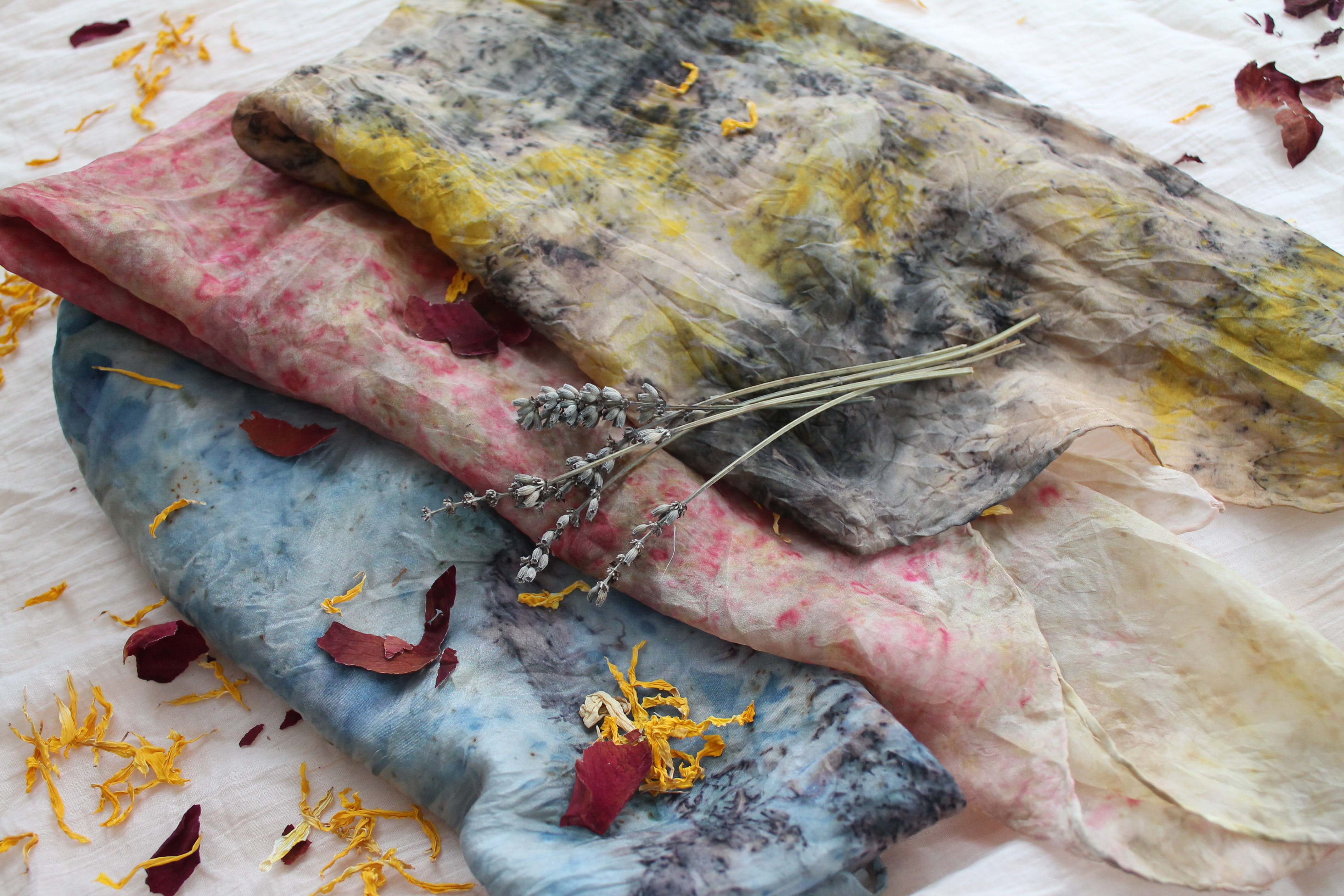 An encaustic painting in shades of blue, yellow, salmon and grey.
