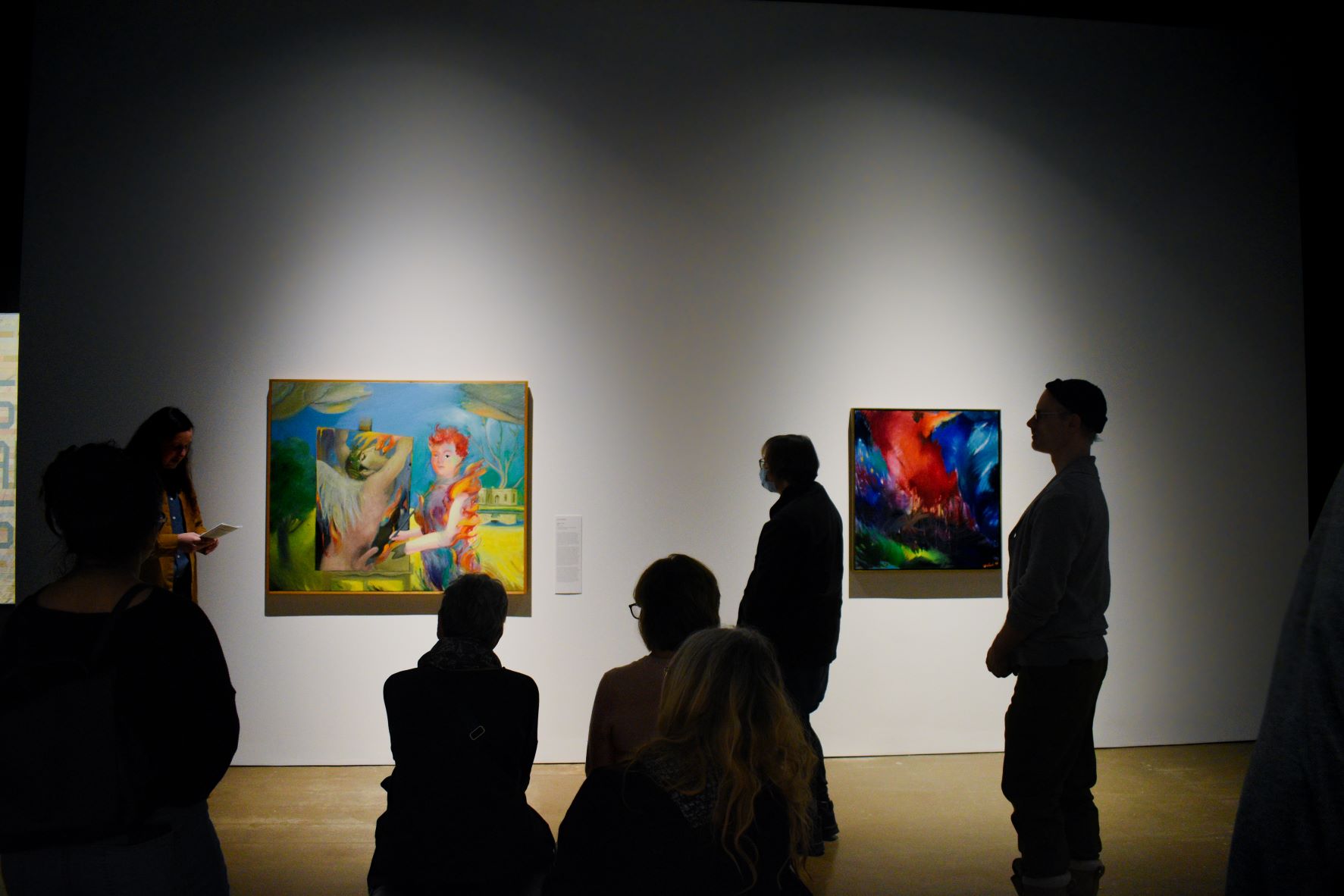 A father and daughter looking at art in the gallery