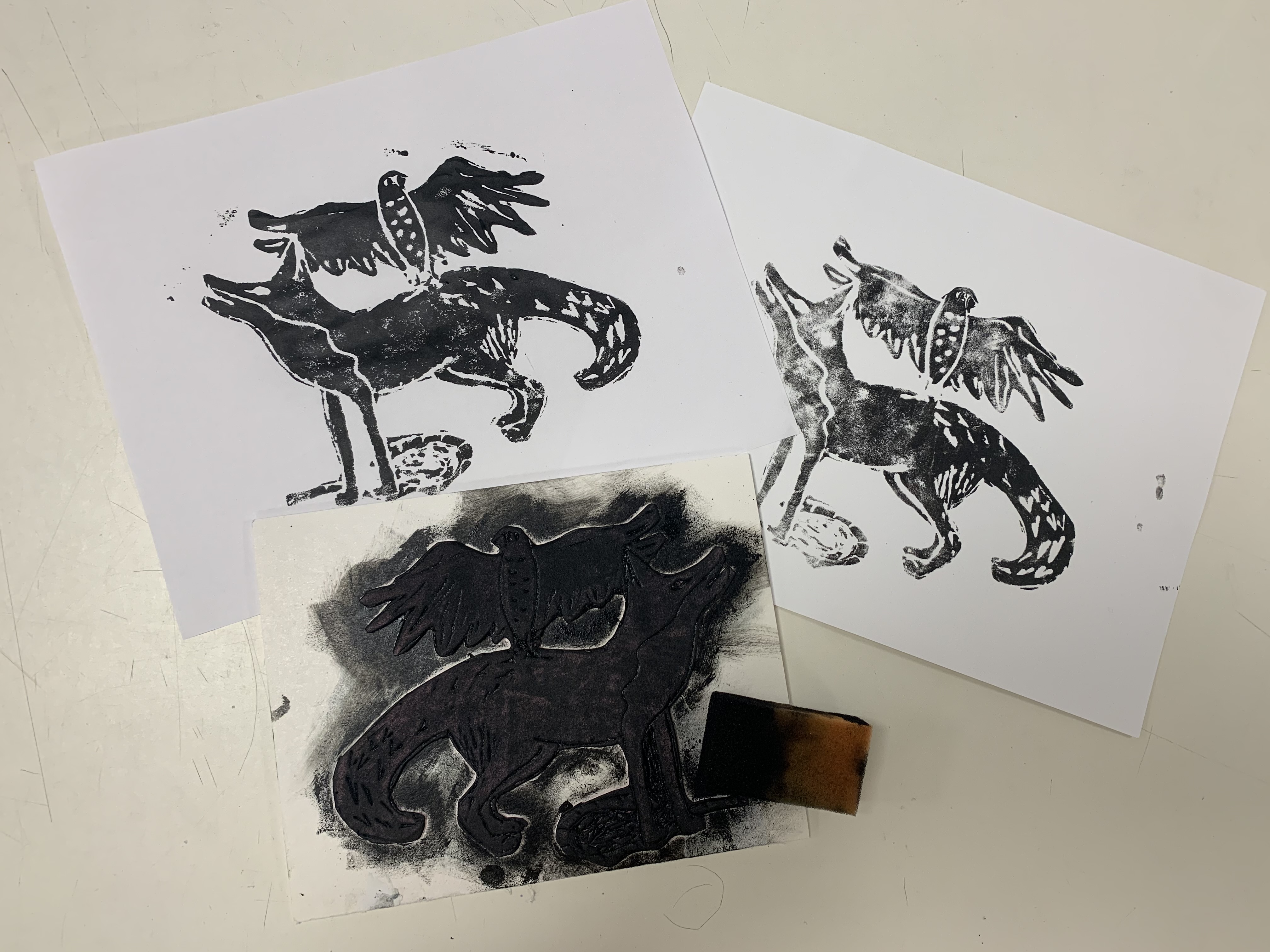 Photograph of print of howling wolf and bird