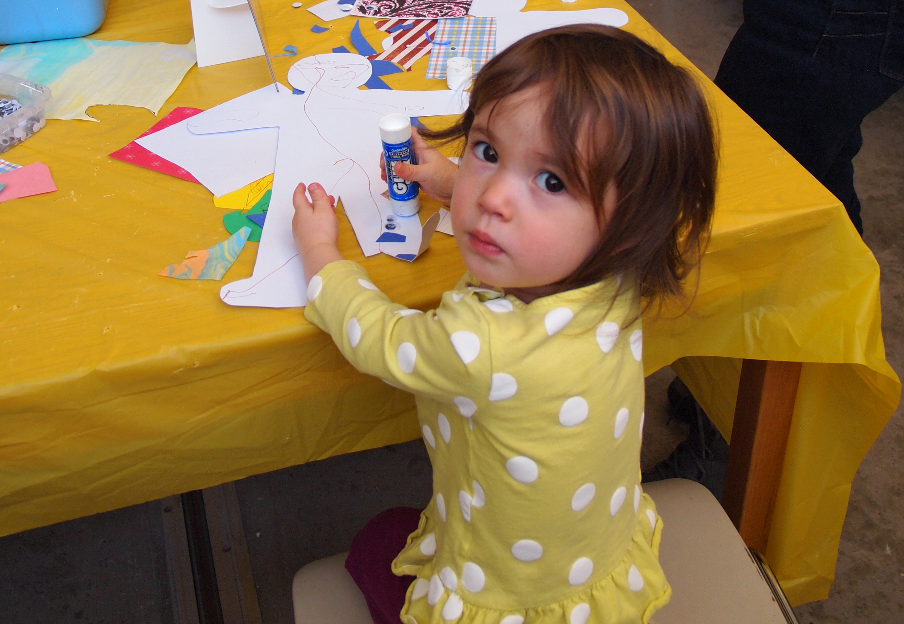 A young girl does crafts at a table