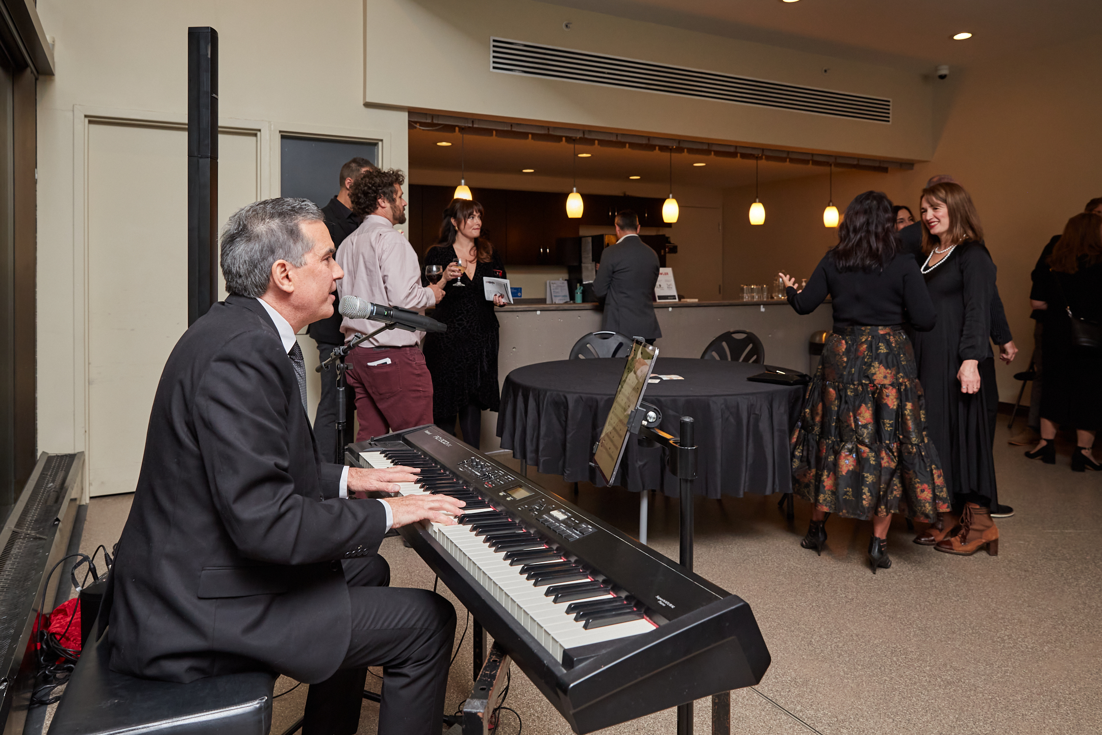 Picture of Tim Louis playing piano in the Community Access space