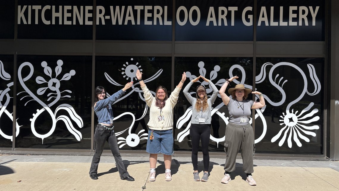 Photo of the four Camp Counsellors posed to spell out the letters of KWAG