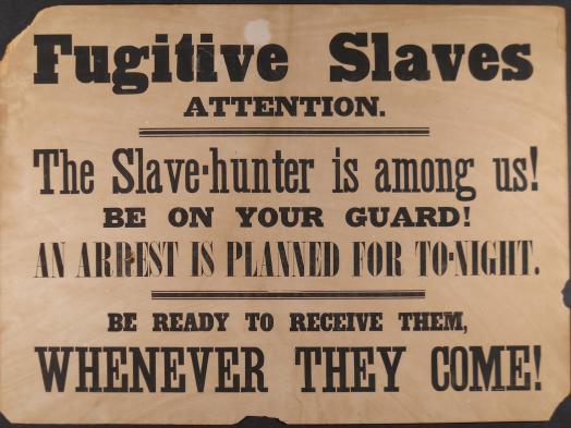 An archival poster reading Fugitive Slaves Attention. The Slave-hunter is among us! Be on your Guard! An Arrest is planned for To-Night. Be Ready to receive them, whenever they come!