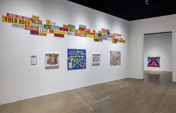 Installation view of FASTWURMS mixed media paintings and colorful text-based metal panels