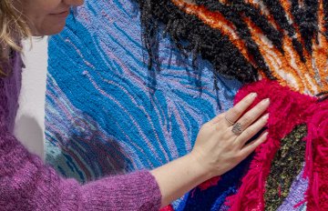 Close-up shot of a person touching a tufted volcano