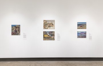 View of a white wall with four  landscape paintings