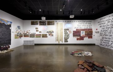 image of gallery exhibition with walls covered in writing