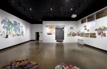 image of gallery exhibition with walls covered in writing