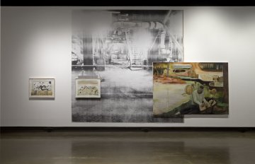 installation view of exhibition showcasing a large black and white image hung on the wall