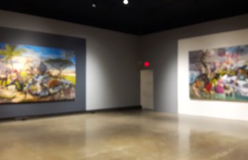 large paintings hung on the gallery walls with large black and white squares framing the paintings