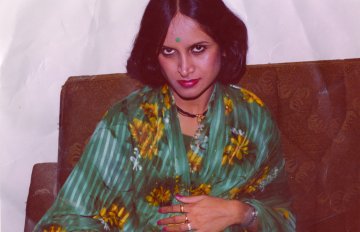 old photograph of a woman in a blue robe sitting on a chair