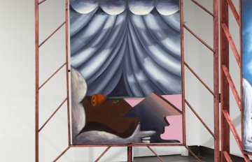 gallery view of exhibition installation. Focus is on a painting of grey curtains with the shadow of a face on them and an arm pointing towards the right