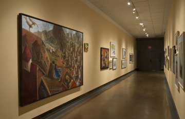 installation view of exhibition in a long hallway