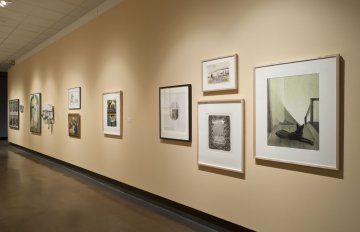 installation view of exhibition in a long hallway