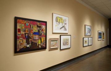 installation view of exhibition in a long hallway