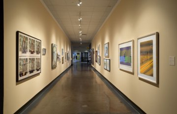 installation view of exhibition in a long hallway