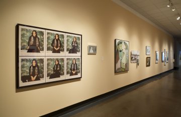 installation view of exhibition in a long hallway