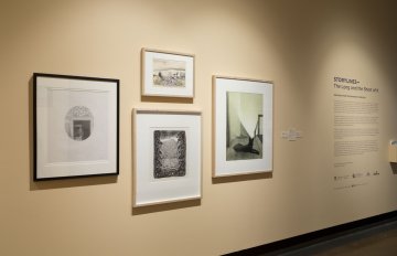 installation view of exhibition in a long hallway