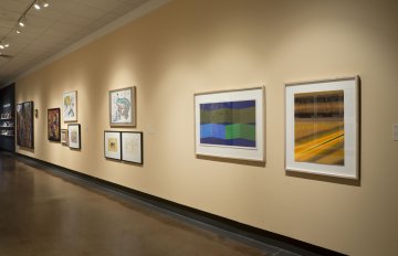 installation view of exhibition in a long hallway