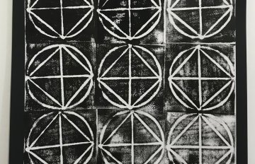 drawing of nine squares with triangles inside them on black paper using a white drawing material