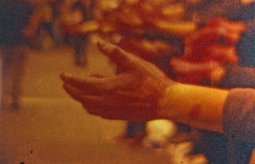 people's hands outstretched in the same direction towards the left