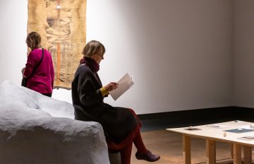 function artwork that makes a sitting place being enjoyed by a gallery visitor while they read