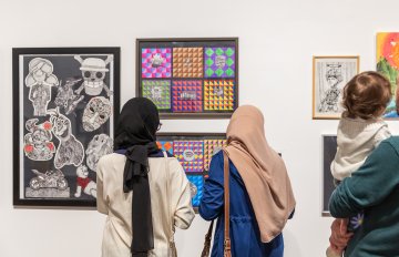 muslim women admiring art hung in the gallery