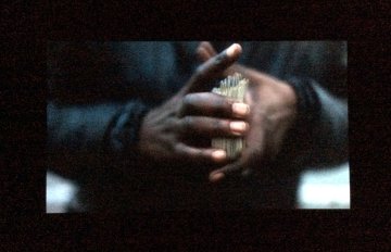 video clip of a black persons hands shuffling cards