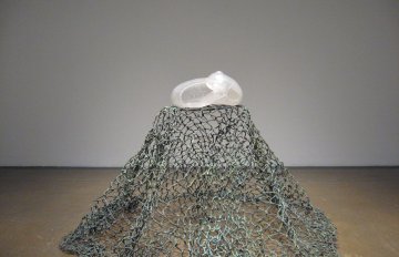 metal cage shaped like a mountain on gallery floor