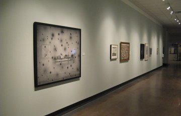 gallery shot of exhibition in long corridor