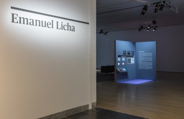 installation view of art exhibition with artist's name Emanuel Licha printed on the wall