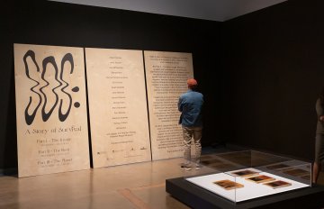 the large wooden signage of SOS exhibition