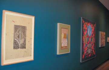 installation view of the exhibition in the long corridor with blue walls