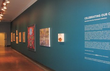 installation view of the exhibition in the long corridor with blue walls