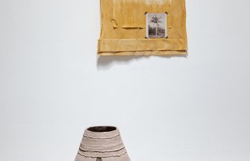Hand dyed cotton, photo print on linen, photo print on archival pape, hanging on a wall with an unfired clay vessel on the ground