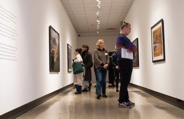 Corridor view of people viewing a Burtynsky framed photo