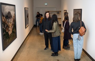 Corridor view of people viewing a Burtynsky framed photo