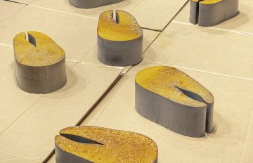 Steel sculptures of char steaks with a rusted look on carboard