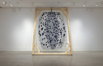 Sealskin sculpture with wool yarn, rug cloth, rug backing pad and felted wool, wood, steel and brass