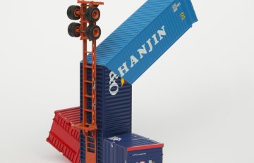 Blue and red colored HO scale model parts of a toy truck merged with shipping containers