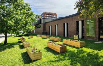 Overhead photo of the verdant Garden of Resilience situated beside the KWAG red brick building