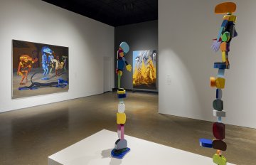Installation shot featuring paintings and sculptures