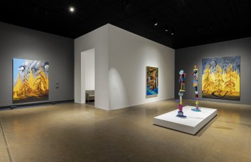 Installation shot featuring paintings and sculptures