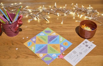 View of a table top with paper stars and stationary